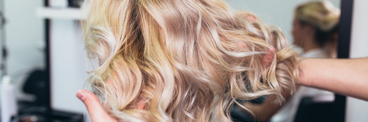 Blonde woman with perfect wavy hair and blue eyes